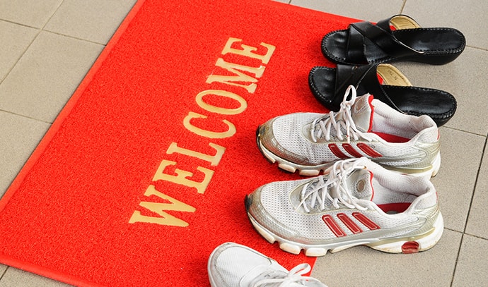shoes-left-on-welcome-mat-near-doorstep