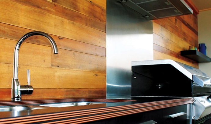 paperock-steel-benchtop-sink-faucet-stove-wood-walls