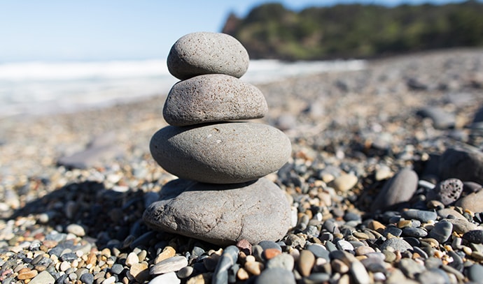 workwell-group-pebble-stones-rock-stack-beach