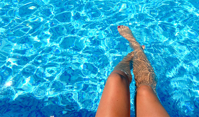 woman-dipping-feet-pool